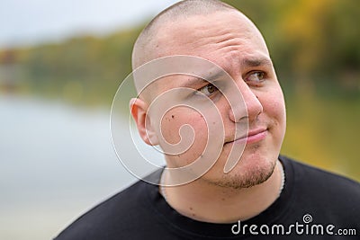 Dubious or confused young man frowning Stock Photo