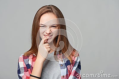 Dubious teen girl thinking biting her finger Stock Photo