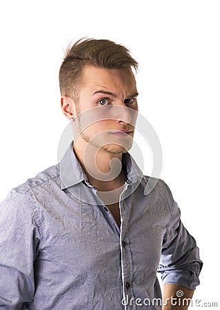 Dubious, unsure handsome blond young man Stock Photo