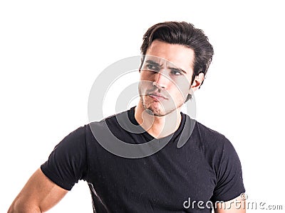 Dubious, unsure handsome young man on white Stock Photo