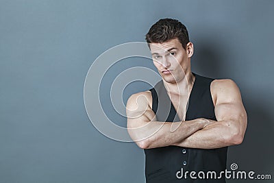 Dubious young man showing his arrogant muscular strength Stock Photo