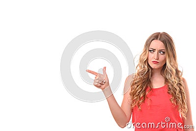 Dubious young woman pointing to the side Stock Photo