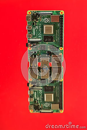 Beautiful closeup view of Raspberry Pi 4 Model B minicomputer on reflective red surface. Creative shot Editorial Stock Photo