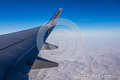 DUBLIN, IRELAND - APRIL 23, 2017: Ryanair logo in the wing of the airplane with sky as the background. Ryanair has cheap flights Editorial Stock Photo