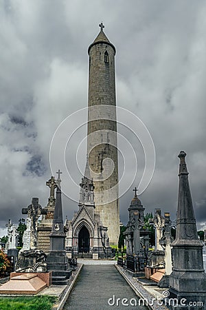 Ancient graves and tombstones in Glasnevin Cemetery with Round Tower, Ireland Editorial Stock Photo