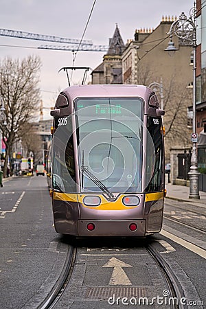 Beautiful vertical closeup view of Luas tram in Dublin city centre beside Stephens Green Green Editorial Stock Photo