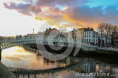 Dublin night scene with Ha`penny bridge and Liffey river lights Editorial Stock Photo
