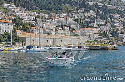 Dubrovnik old town harbor atmosphere with local small boats moored Editorial Stock Photo