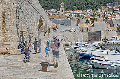 Dubrovnik old town harbor atmosphere with local small boats moored Editorial Stock Photo