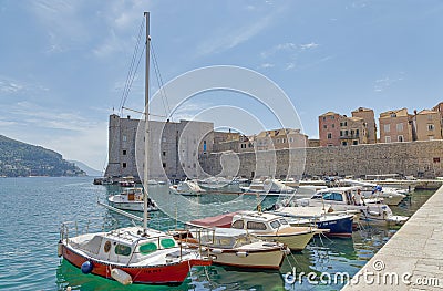 Dubrovnik old town harbor atmosphere with local small boats moored Editorial Stock Photo