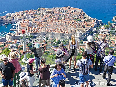 Tourists looking out over panorama view of old town of Dubrovnik from viewing platform Editorial Stock Photo