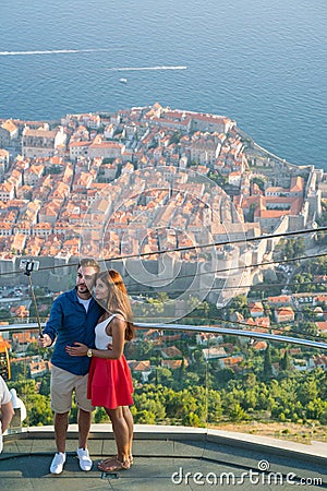 Dubrovnik, Croatia - July 21, 2016: couple making selfie on the background of the old town Editorial Stock Photo