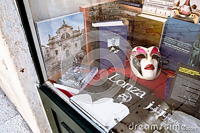 Window display of souvenir shop, book and mask in Dubrovnik, Croatia Editorial Stock Photo