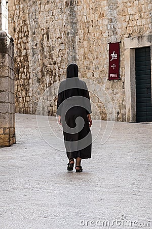 Dubrovnik, Croatia - Jun 21, 2020: Woman at the Dominican Monastery in Dubrovnik, Croatia Editorial Stock Photo