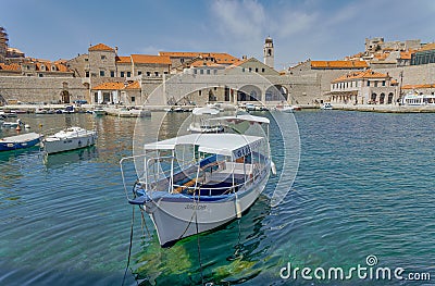 Dubrovnik old town harbor atmosphere with local small boats moored Editorial Stock Photo