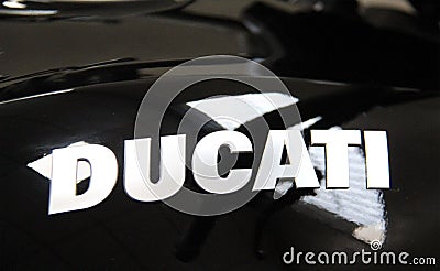 Ducati motorcycle: Close up on Ducati inscription on a black fuel tank Editorial Stock Photo