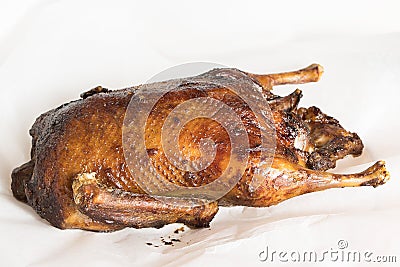 Duck baked until golden brown lies on a light background,, Stock Photo