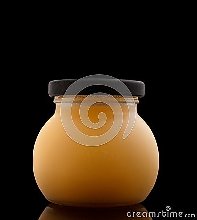 Duck fat in jar on black background Stock Photo