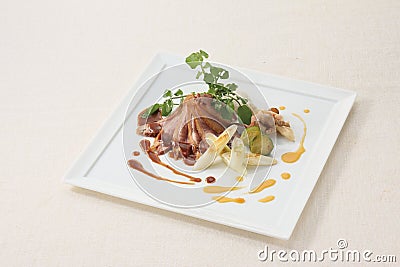 Duck roast truffle and orange two-color source on white plate ba Stock Photo