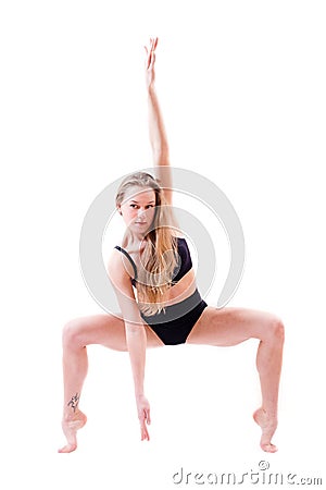 Ductile flexible beautiful blond young woman performer dancer standing on tiptoe bent knees isolated on white Stock Photo