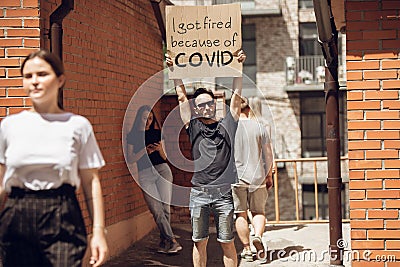 Dude with sign - man stands protesting things that annoy him Stock Photo