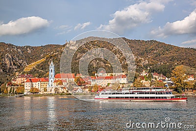 DUERNSTEIN CASTLE AND VILLAGE WITH BOAT ON DANUBE RIVER IN AUSTRIA Stock Photo