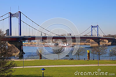 View over green pasture pensinsula MÃ¼hlenweide at river rhine on Friedrich Ebert bridge against blue sky in winter Editorial Stock Photo