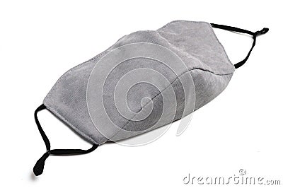 A dull light grey cotton face mask with black elastic rubber secure bands Stock Photo
