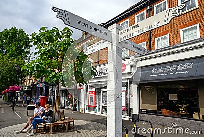 A local sign in Dulwich Village with people and shops Editorial Stock Photo