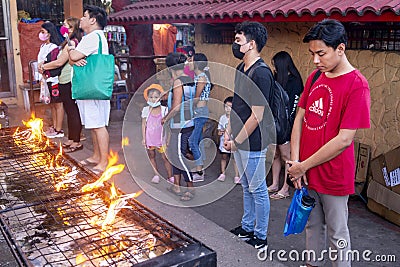 Filipinos gather to pray and light religious candles,at a holy shrine next to the iconic Dumaguete Belfry,that helped save the Editorial Stock Photo