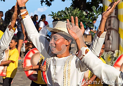 Dumaguete, Philippines - 16 September, 2017: Sandurot Festival dancer in grass hat. Editorial Stock Photo
