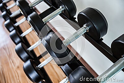 Dumb bells lined up in a fitness studio. picture is short focus Stock Photo