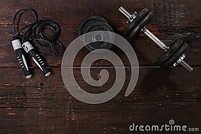 Dumbbell and a skipping rope Stock Photo