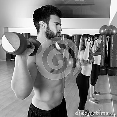 Dumbbell weightlifting man women group at mirror Stock Photo
