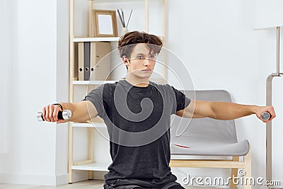 health man training activity indoor sport gray lifestyle home athlete dumbbells Stock Photo