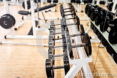 Dumbbells in modern sports club, gym or fitness center Stock Photo