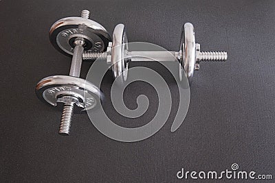 Dumbell on isolated black background, pair of silver dumbells Stock Photo