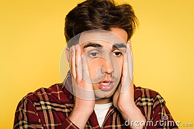 Dumbfounded man clutching head panicking emotion Stock Photo