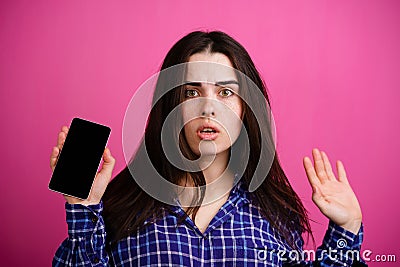 Dumbfounded woman with smart phone in hand Stock Photo