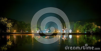 Lake night scene with windmills Stock Photo