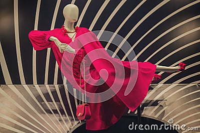 Dummy in a magnificent red dress in a show-window of shop Stock Photo