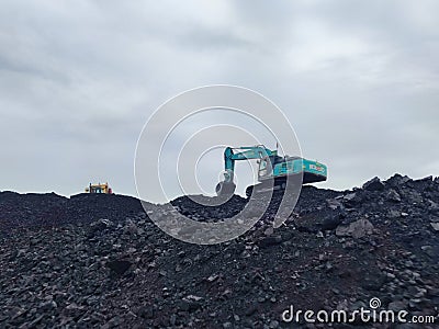 Dump Truck and Excavator Worker mining metal Tantalum and silver. Mining business, Mineral Resources. Editorial Stock Photo