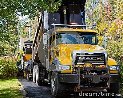 Dump truck and paving machine Editorial Stock Photo