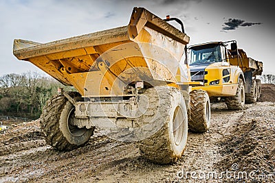 Dumper Truck and Lorry in Mud on Construction Site Stock Photo