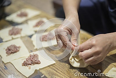 The dumpling making. Meat in dough. Cook prepares dumplings Stock Photo