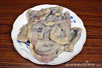 Dumplings with blueberries on a plate Stock Photo