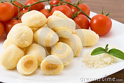 Dumplings stuffed with mozzarella and tomato sauce Stock Photo