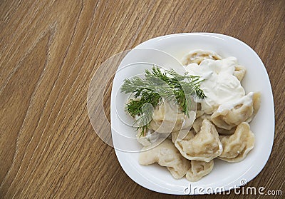 Dumplings stuffed with potatoes with sour cream Stock Photo