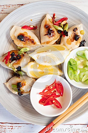 Dumplings styled with lemons green onion and red chili Stock Photo
