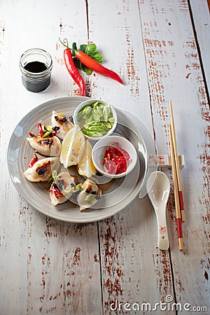 Dumplings styled with lemons green onion and red chili Stock Photo